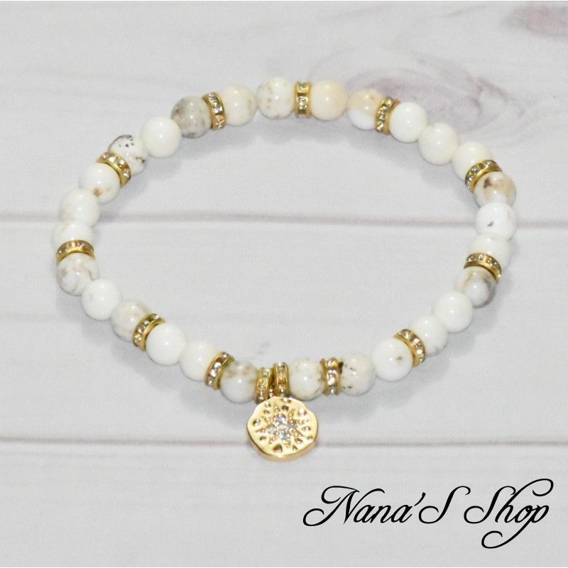Bracelet élastique en Magnésite de couleur blanche, strass et pendentif étoile en métal doré. Bracelet élastique en Magnésite de couleur blanche, strass et pendentif étoile en métal doré.
