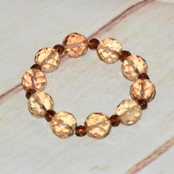 Bracelet en grosse perles de cristal, coloris marron.