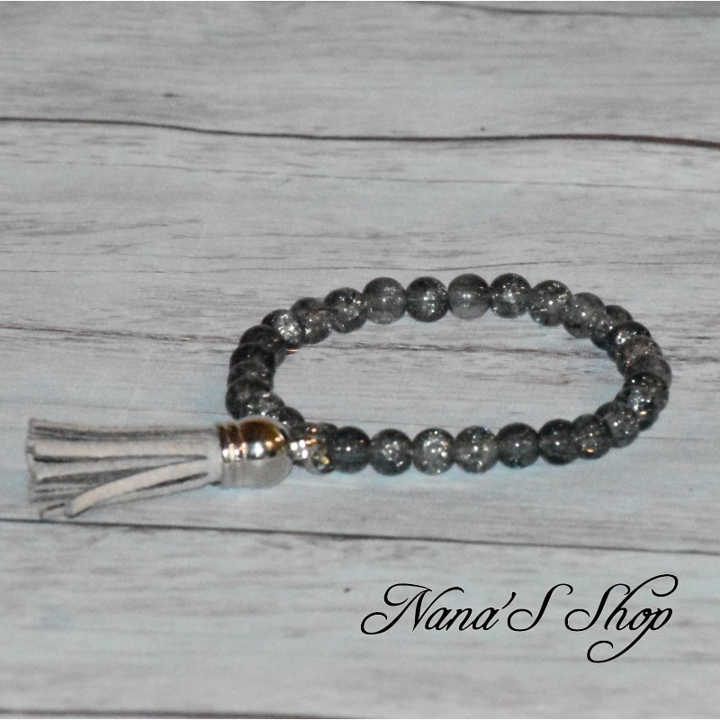 Bracelet fantaisie, perles de verre craquelés et tassel, coloris gris. Bracelet fantaisie, perles de verre craquelés et tassel, coloris gris.